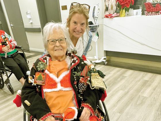 Resident Shirley McKin, left, won second place at the Parkside Center for Nursing and Rehabilitation’s ugly Christmas sweater contest. Her daughter, Cheryl Adams, right, celebrates her victory.