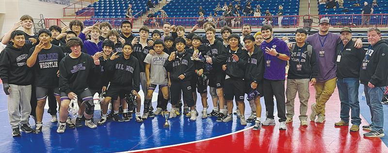 Gilmer wrestlers and  coaches celebrate the Bobcats’ third place finish at the Class 3A state duals  last Saturday. GHS posted a 4-1 record to improve to 25-2 overall on the season.