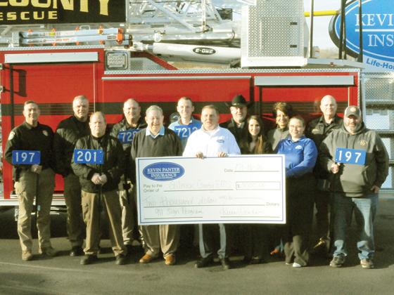 Emergency services personnel and supporters line up in front of a firetruck. Shown from left are, front row, Gilmer County Fire Department Deputy Chief of Operations Mike Dempsey, Commissioner John Marshall, Kevin Panter, Kim Blair, Tara Deen, Manager Robbie Harbour; and, back, Ellijay Police Chief Edward Lacey, Deputy Fire Chief Jason Bryant, Public Safety Chief Sam West, Austin Panter, Sheriff Stacy Nicholson, Stacie Nicholson and East Ellijay Public Safety Director Larry Callahan.