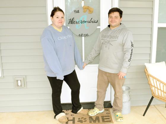 Taylor Abercrombie, left, and Chris Abercrombie, right, celebrate moving into their new house, built in cooperation with Habitat for Humanity.
