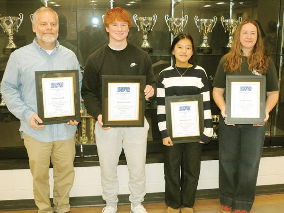 Teachers and STAR students celebrate receiving awards. Shown from left are teacher Heath Hinton, STAR student Harper Davenport, STAR student Rose Bawihnem and teacher Mary May.