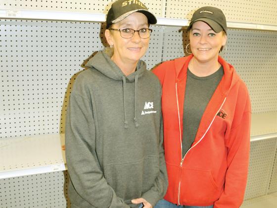 Ace Hardware Inventory Manager Shanan Pittman, left, and Floor Clerk Abby McCollum, right, stand by shelves where heaters and other winter supplies have sold out.