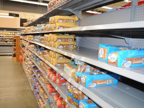 Walmart employees restock bread as Gilmer customers prepare for a major winter storm.
