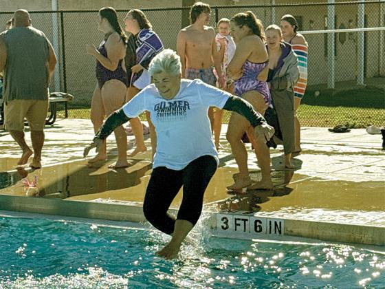 Gilmer County Commissioner Karleen Ferguson jumps into the Gilmer County Rec Department Pool Thursday, Jan. 1. She took the plunge as part of the Freeze for the Team fundraiser. Proceeds went to support the local swim team and the Gilmer County Animal Shelter.