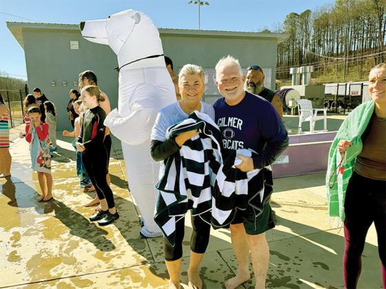 Karleen Ferguson, left, and Robert Ferguson, right, celebrate a successful Freeze for the Team fundraiser as participants dry off. The event was free, but participants were asked to donate money.