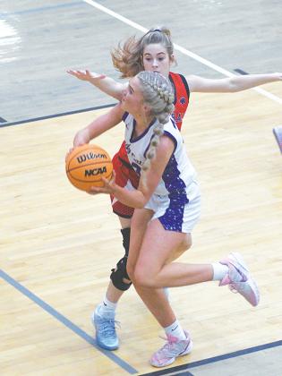Gilmer’s Jace Sanderson drives to the basket versus Heritage last Friday and led the Lady Cats with 22 points.