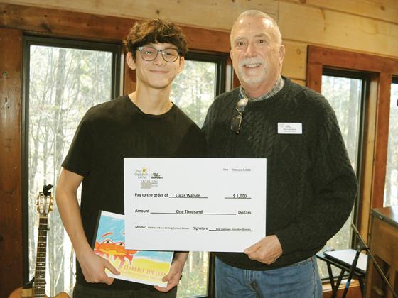 17-year-old Lucas Watson, left, receives a $1,000 check from Craddock Center Executive Director Kirk Cameron, right.