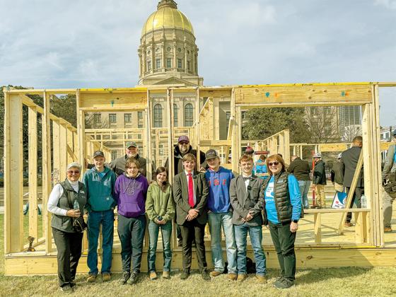 Habitat for Humanity volunteers and leaders work to build a house in front of the Georgia State Capitol. Shown from left are, front, Gilmer County Commissioner, Karleen Ferguson, Clint Carver, Johnathan Johnson, Alivia Richards, Jesse McElreath, Cole Bolinger, Kyle Gee and Habitat for Humanity Georgia President and CEO Donna Lusk; and, back, Audio, Video, Technology and Film teacher Robert Ferguson and Construction teacher BJ Chancey. (Contributed photos)