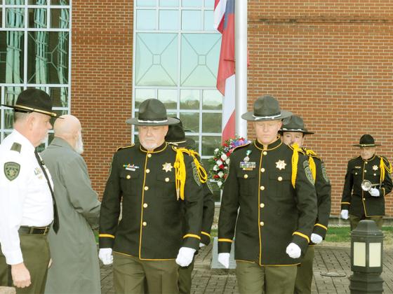The Gilmer County Sheriff’s Office Honor Guard lowers the flag to half-mast to honor Deputy Sheriff Brett Dickey, who died in the line of duty.
