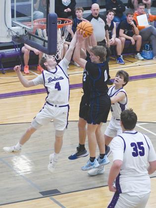 Bobcat Jaden Sevcech battles for a rebound and Gilmer began the region tournament at press deadline.