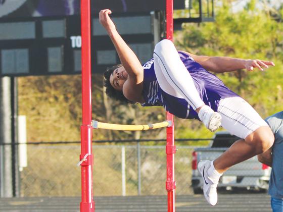 Gilmer High’s  Jeremiah Few eyes the bar as he begins to clear it in the high jump.