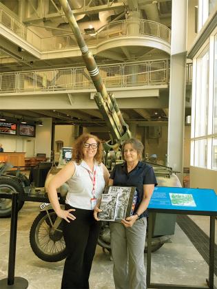 A museum employee, left, and author Kathy Williams, right, remember history at the National WWII Museum in New Orleans, La., 2016.