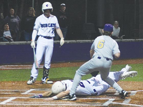 Gilmer High School junior Jayden Grizzle slides safely home on a wild pitch.