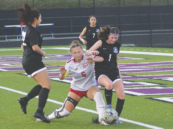 Gilmer’s Autumn Little (1) diffuses a Cherokee attack last Tuesday.