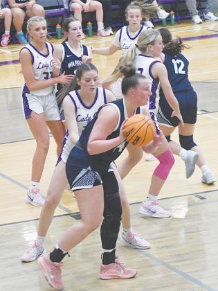 Senior Chelsey Griggs plays on-ball defense as teammates from left, Jace Sanderson (33), Mak Taylor and Paula Robertson help defend the paint versus White County.