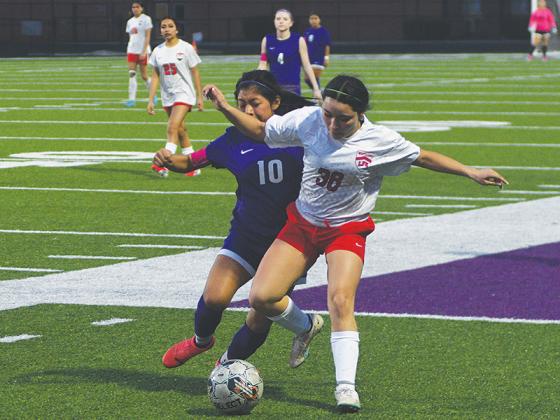 Lady Cat Selina Tercero battles for the ball.
