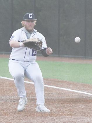 Bobcat senior Cooper Cochran fields a grounder at first for an out.