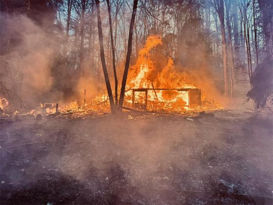 A structure at Novena Court in Coosawattee burns in the early morning on Sunday, March 29.
