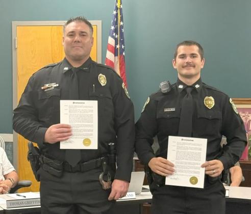 Ellijay Police Department Officer Allen O’Neal, left, and Oficer Dawson Young, right, receive their Police Commendation Awards for rescuing a runaway 12-year-old girl.
