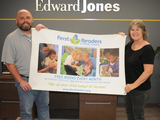 JE 5-06 KidsFerst 1: Josh Chancey, left, and Barbra Jones, right, hold a banner for KidsFerst in Gilmer County.