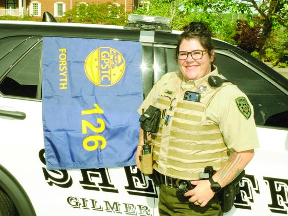 Deputy Savannah Banks celebrates her graduation alongside the Session 126 class of the Georgia Public Safety Training Center.