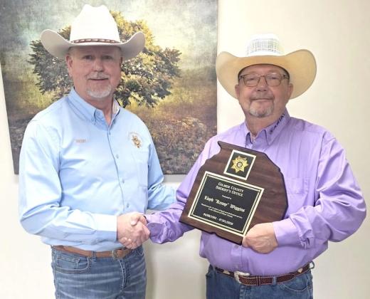 Sheriff Stacy Nicholson, left, celebrates the retirement of Deputy Lloyd “Kenny” Wiggins, right.