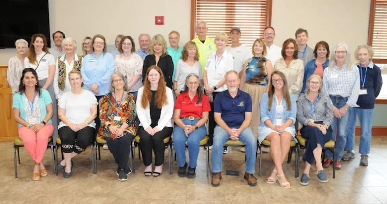 Nonprofit leaders, volunteers and other supporters take a photo together to celebrate the work of the Faith, Hope and Charity (FHC) Recycle Store. Shown from left are, first row, FHC volunteer Laila Wood, FHC volunteer JoAnn Davis, FHC Manager Liceann Strauss, Women Together Period Inc. Executive Director Emilyn Slemons, Friends of Gilmer Animal Shelter President Sylvia Harris, The Joy House Executive Director Steve Lowe, Court-Appointed Special Advocate (CASA) Volunteer Supervisor McKenzi Farris, FHC volun
