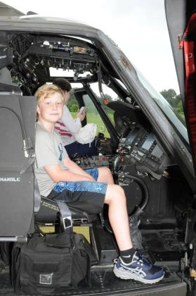 Ryker McCollum sits at the controls of a National Guard Blackhawk helicopter.