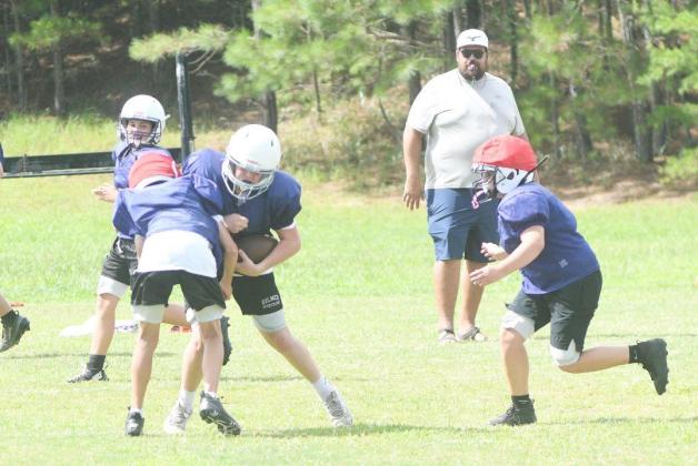 Clear Creek offensive coordinator Taylor Johnstone looks on as players collide at practice last Thursday.