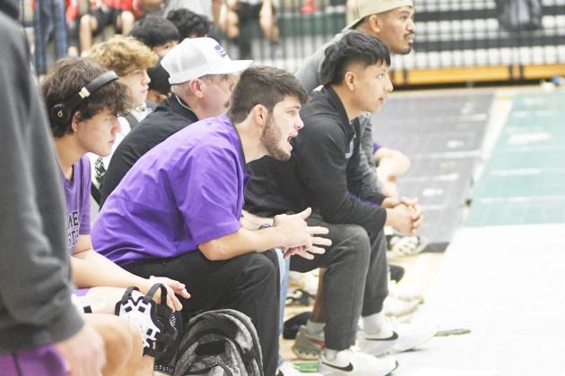 Caleb Waddell (in purple) gives instructions during his first season as Gilmer’s head coach last year.