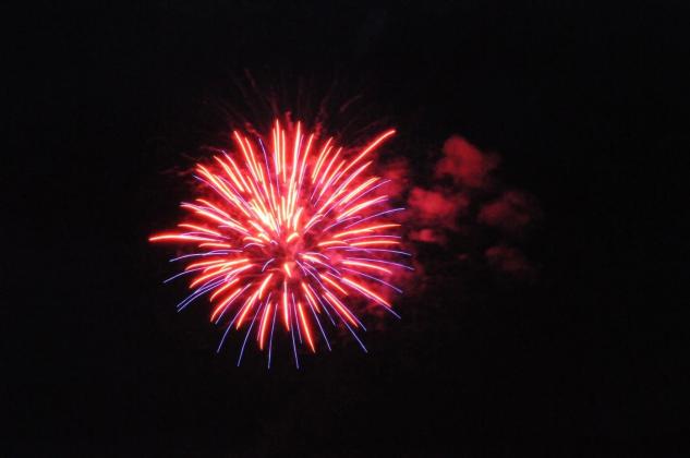 A red firework lights up the sky on America's 250th July Fourth in Ellijay, Georgia.