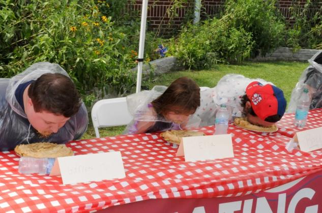 Contestants engage in a pie-eating contest in downtown Ellijay. Shown from left are Garrett Martin, Gabriella Monzent, Sam Berry, Harrison Gilbert and Ray Jerauld.