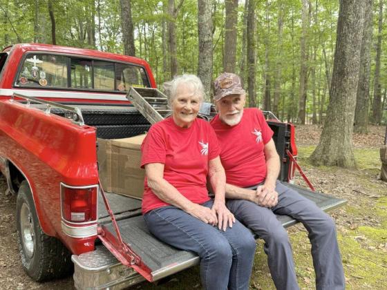 Sue Wheeler, left, and her husband, Army veteran Ron Wheeler, right, celebrate getting a new roof from Phoenix Roofing Systems as part of the company's Operation Rooftop Rescue.