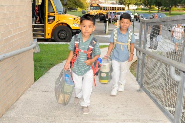 Yace Leon, left, and Maximus Leon, right, arrive for their first day at Ellijay Elementary School on Monday, Aug. 3.