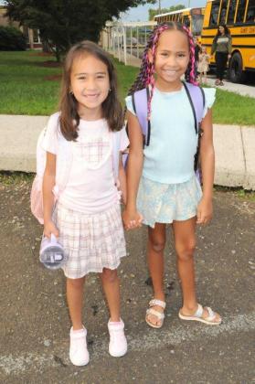 Kamila Balderas, left, and Amora Ledford, right, share a moment together after arriving at Ellijay Elementary School on Monday, Aug. 3.