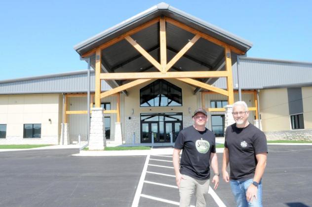 Worship pastor Jeff Parker, left, and senior pastor Steve Dusek, right, celebrate the completion of The Orchard Church's new building.