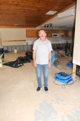 Coosawattee Shrine Club member Buster Stover stands in the club's building after flash floods on Tuesday, July 28, caused severe water damage.