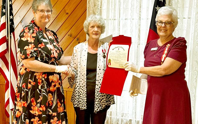 Alice Adkins, center, was recently awarded the National Defense Medal by the Nancy Harts Chapter 2728 of the United Daughters of the Confederacy.