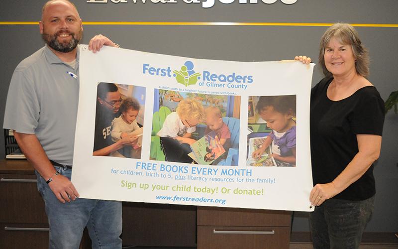 JE 5-06 KidsFerst 1: Josh Chancey, left, and Barbra Jones, right, hold a banner for KidsFerst in Gilmer County.