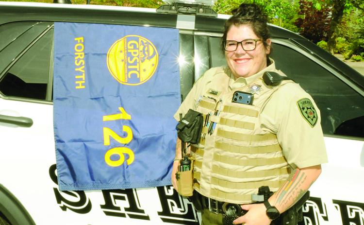 Deputy Savannah Banks celebrates her graduation alongside the Session 126 class of the Georgia Public Safety Training Center.