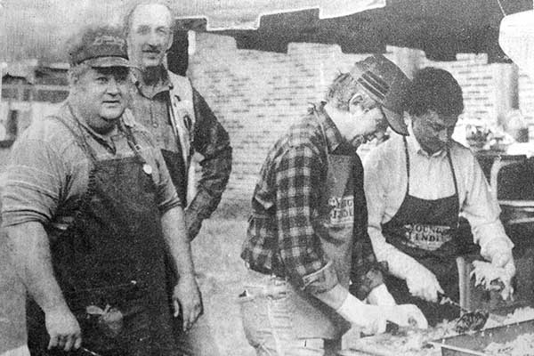 In 1986, Lions Club members James Pack, Bill Middleton, Michael Bramlett and Tracy Newton prepare barbecue plates for hungry attendees at that year’s 15th annual Georgia Apple Festival. The festival has since grown to become the club’s biggest annual fundraiser.