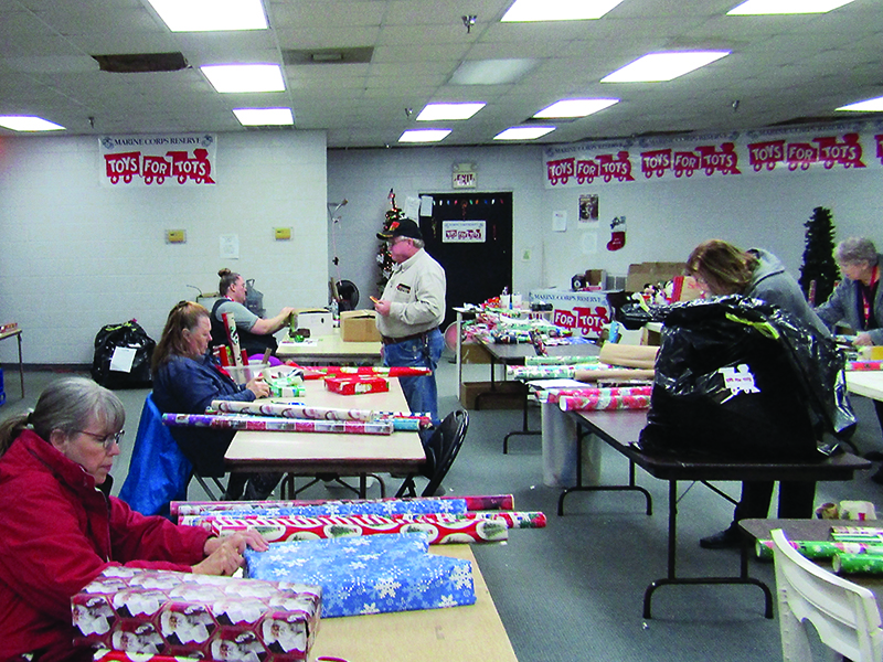 Wrapping gifts is one big way that volunteers help the local Toys for Tots distribution effort come together each year. 