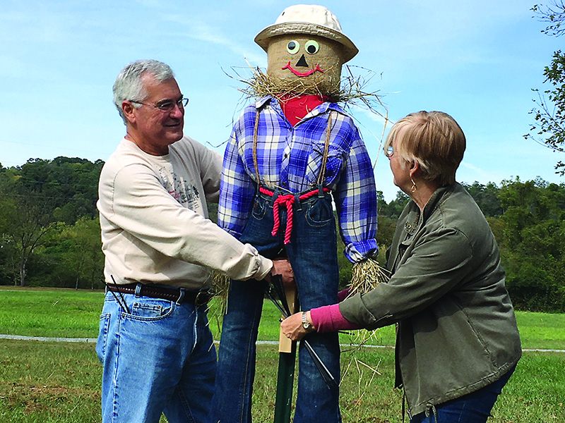 Friends of Harrison Park Mike and Linda Lancaster put up one of many scarecrows now on display at the downtown Ellijay park.  The scarecrows will be up through Halloween and contest winners will be announced at the Harrison Park Chili Challenge Oct 26.