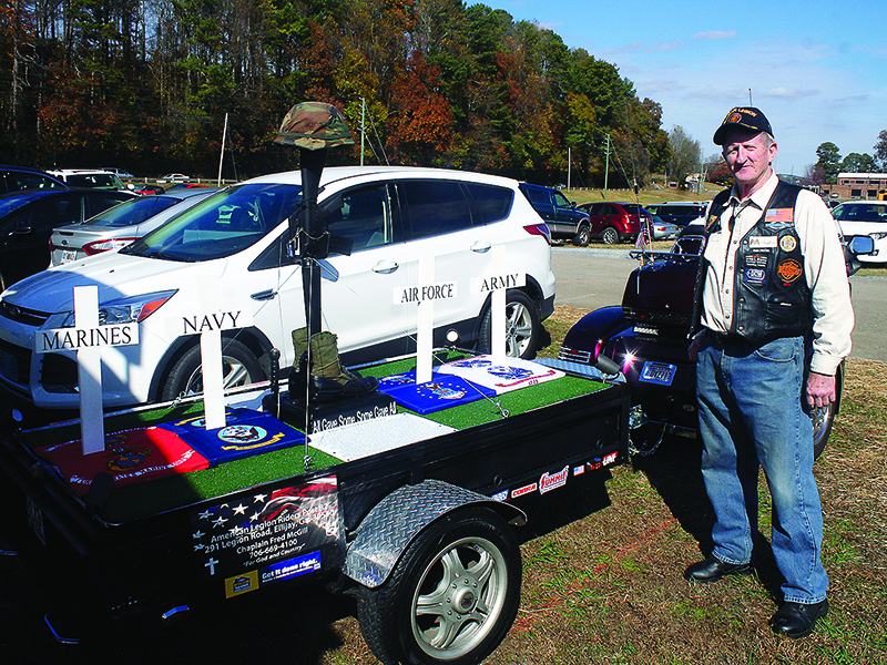 Fred McGill, chaplain for Ellijay’s American Legion Post 82, shows his battlefield cross trailer recognizing different U.S. military branches.