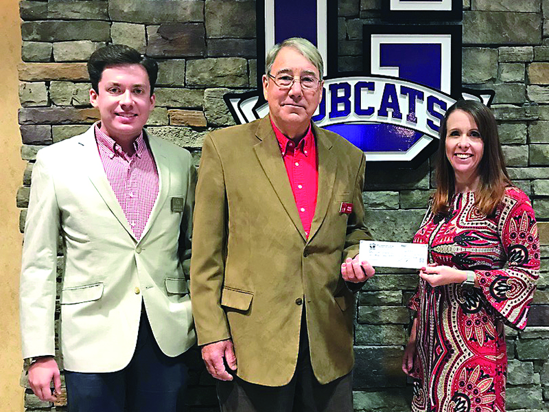 Apple Country Auto Club Treasurer Andrew Miller, left, and president Ronnie Prater, center, present Gilmer Charter Schools Superintendent Dr. Shanna Downs with a donation check that will fund a scholarship for a student enrolled in the auto tech program at Gilmer High School.