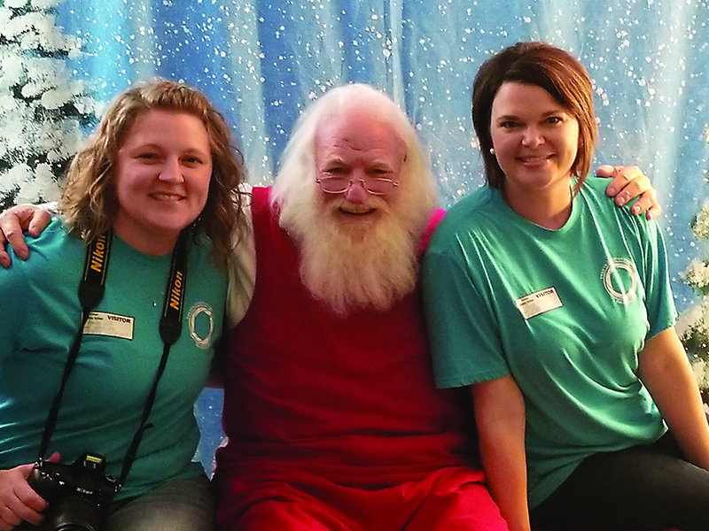 Santa (Jack Senterfitt) will team up with local photographers Haley Vick, left, and Gena Farmer, right, for an upcoming Sensory Santa event at Clear Creek Elementary School. Anyone who has children with special sensory needs can make an appointment for a Santa visit and photo session.
