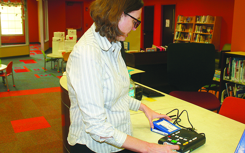 Jessica Tibbetts, adult services coordinator at the Gilmer County Library, demonstrates a GLASS talking book reader that can be used by persons with eyesight challenges.