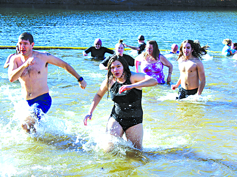 Participants hustle to get out of the 52-degree lake. 