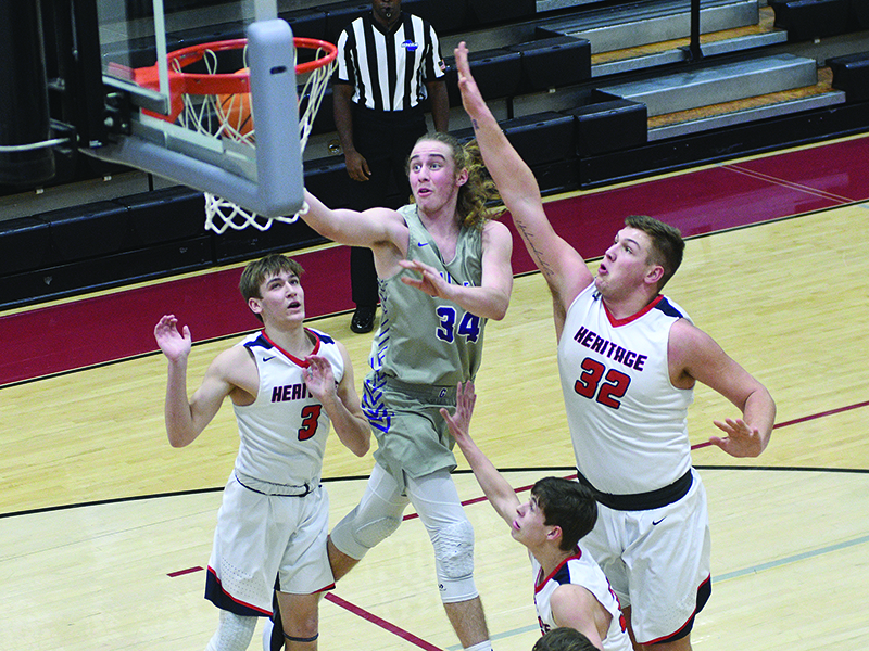 Bobcat Cade Carter drives for two of his team-high 20 points versus Heritage.