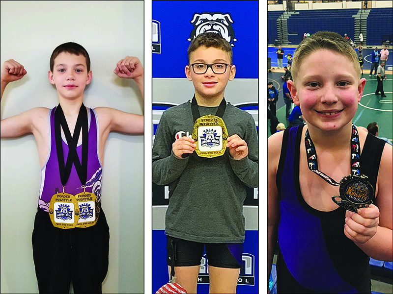 From left, are Gilmer youth wrestlers Isaiah Goodwin, Keigan Brookshire and Parker Settel. Goodwin and Brookshire both finished first in their weight class at last weekend’s tournament in Trion. Goodwin and Settel also won a champion’s belt for points accumulated based on their finishes at six tournaments during the USA Wrestling season.
